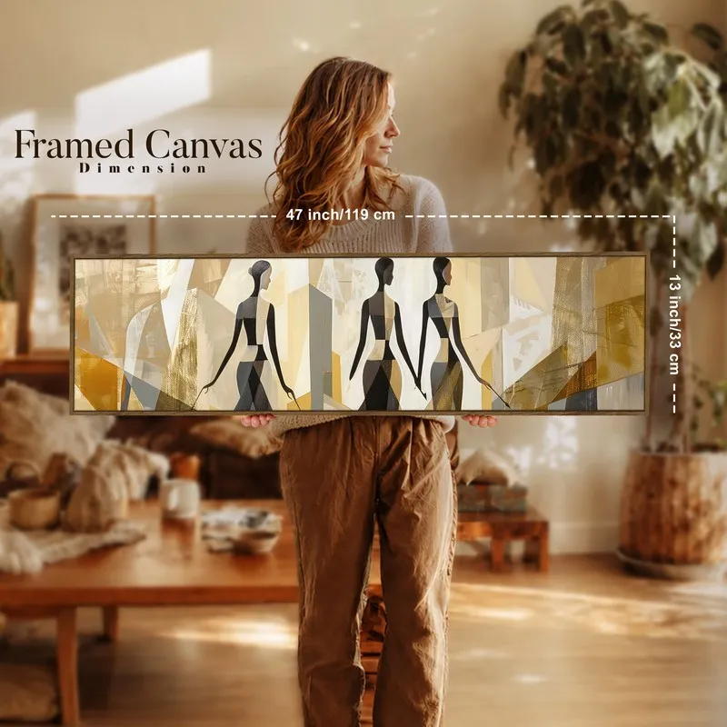 Woman holding a long framed silhouette canvas in a warm living room setting