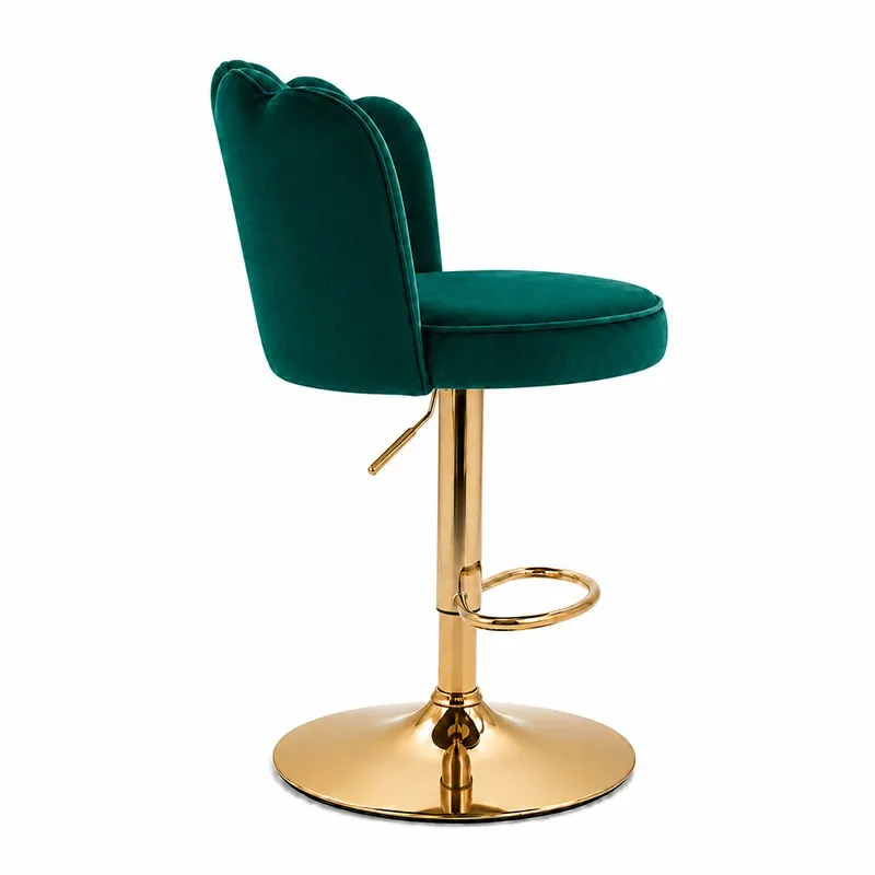 Side view of green velvet bar chair with curved back and gold-toned pedestal base
