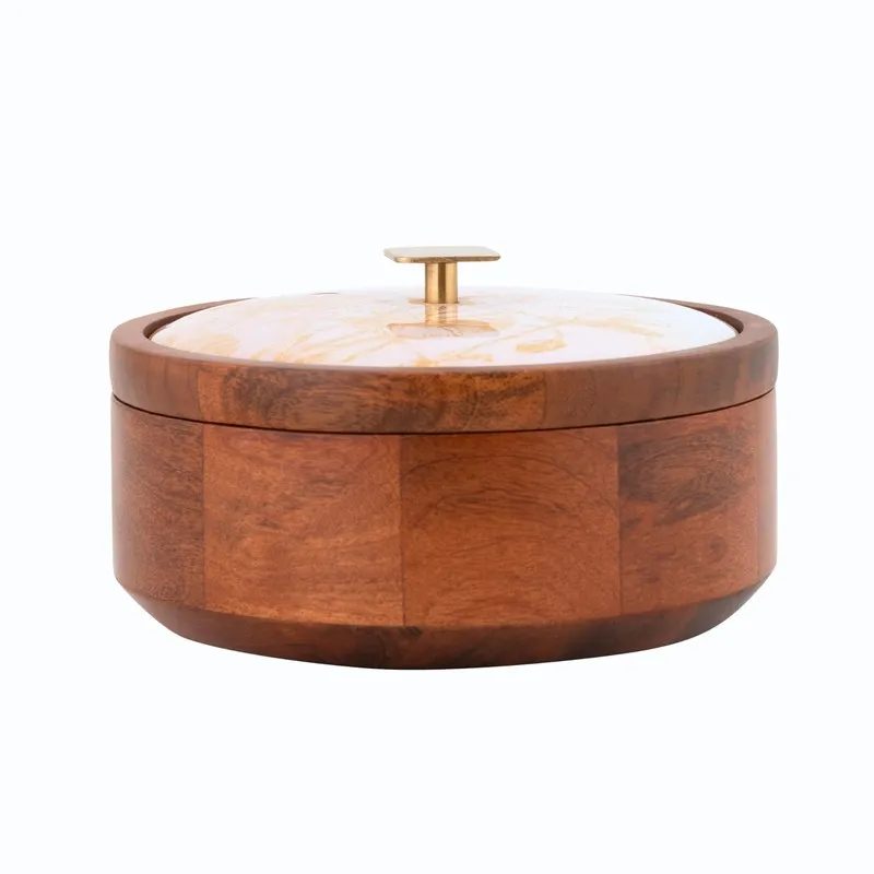 Front view of closed round brown wooden masala box