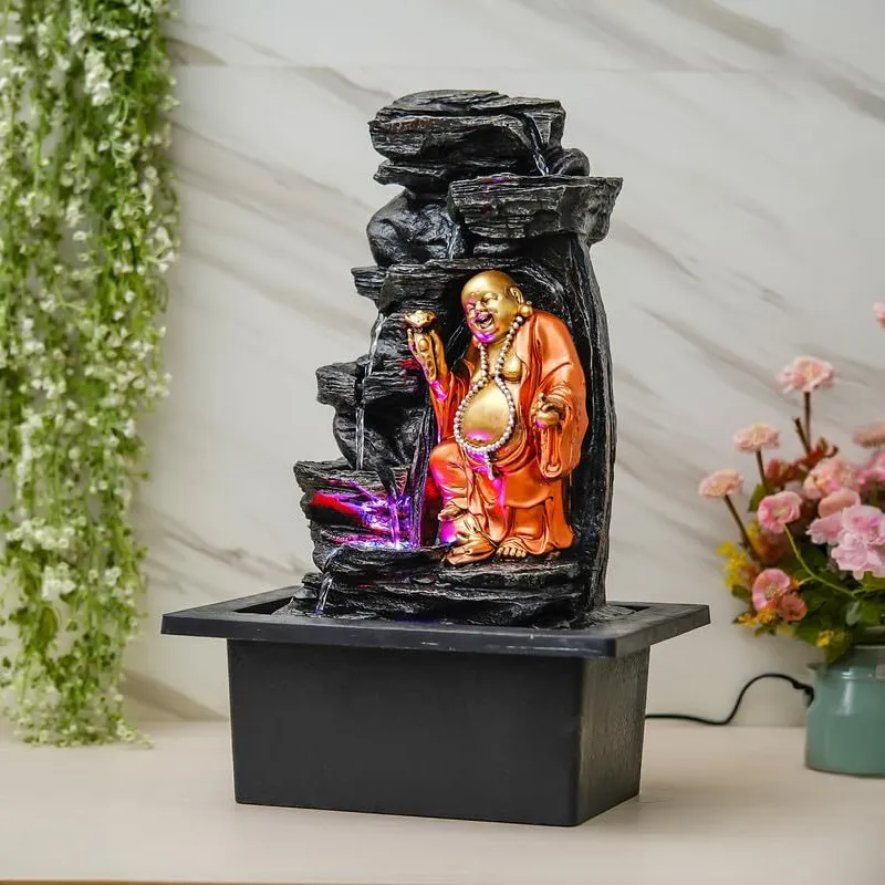 Angled view of Laughing Buddha fountain with illuminated water flow