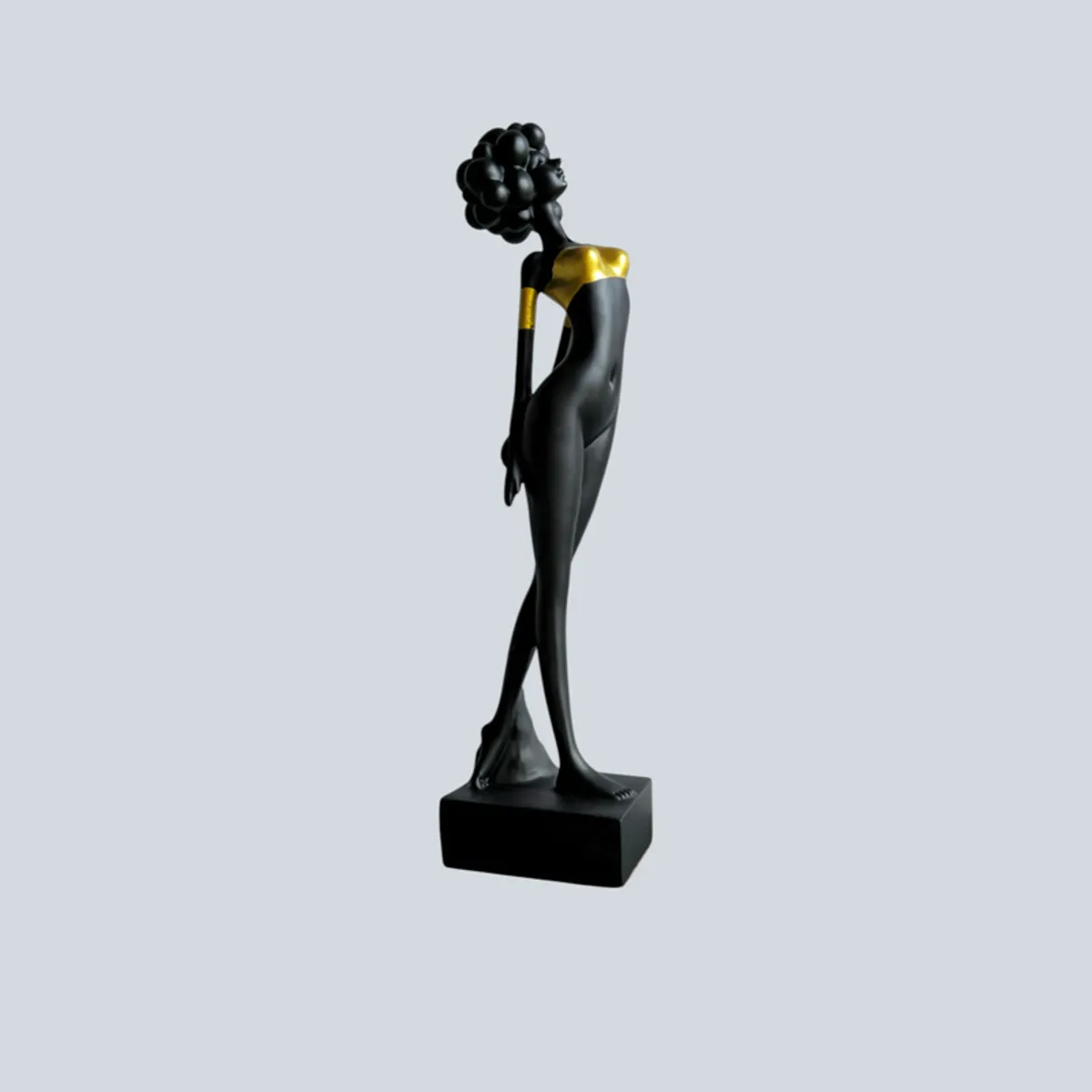 Angled view of a tall black and gold lady figurine on a base