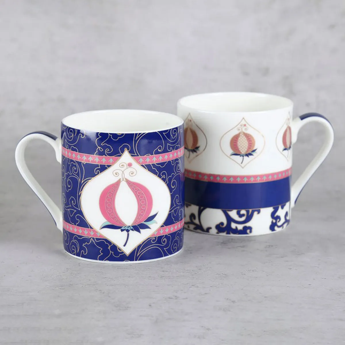 Blue and white pomegranate-patterned mugs shown from the opposite side