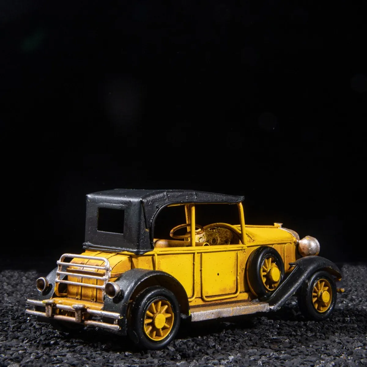 Rear angled view of the yellow vintage model car showpiece