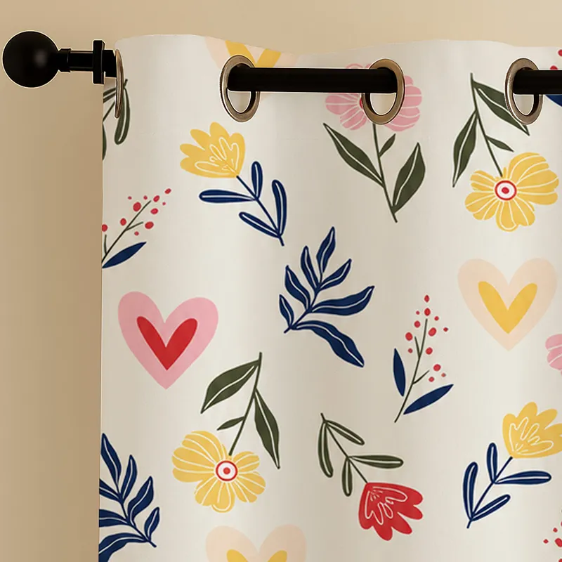 Close-up of floral and heart print curtain with metal eyelets.