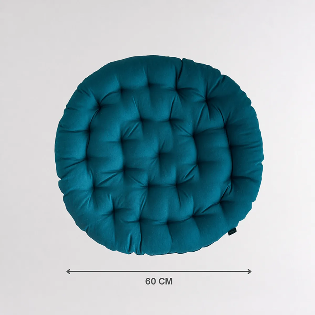 Single round deep green tufted floor cushion shown from the front