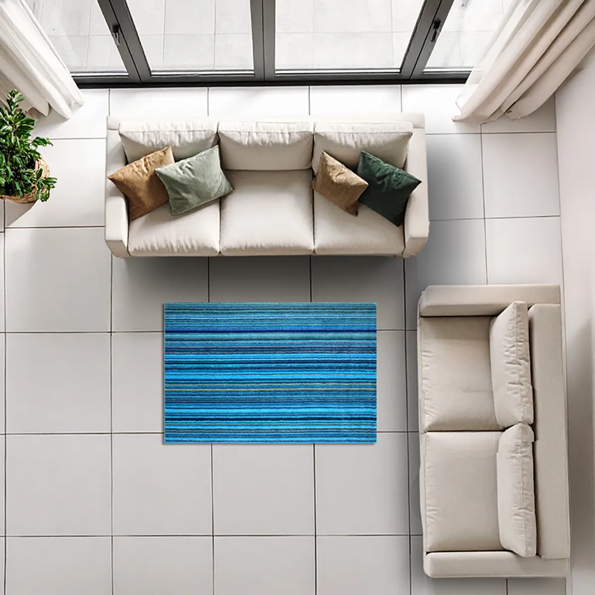 Blue striped carpet placed between sofas in a bright tiled room