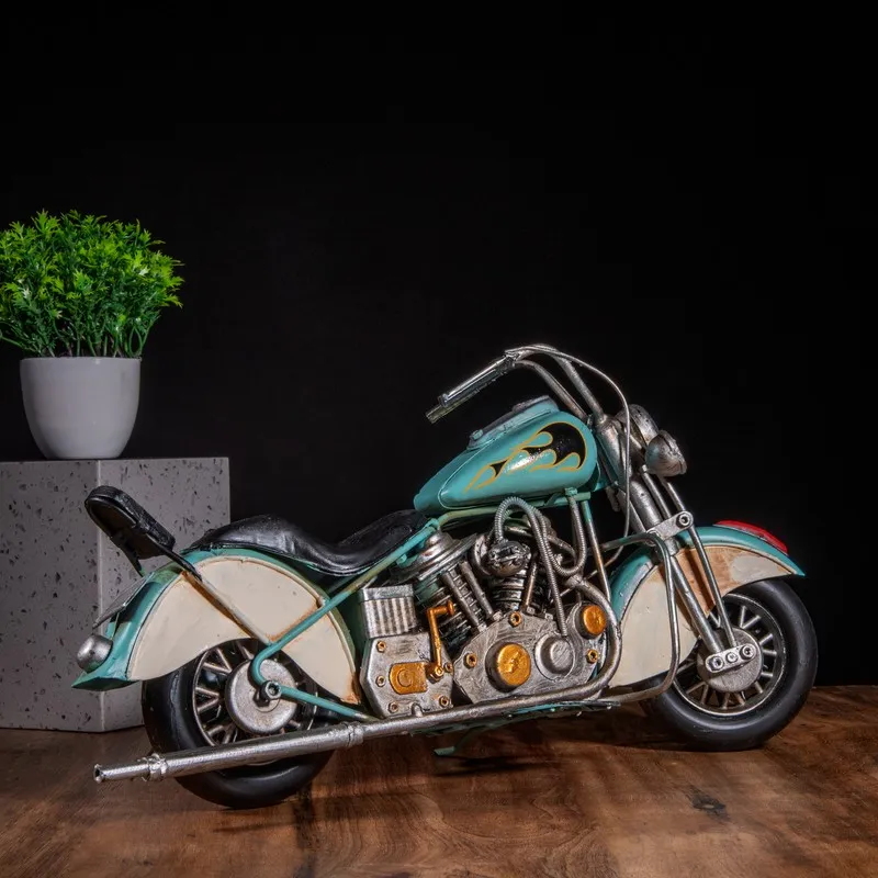 Blue antique-style motorcycle showpiece with detailed engine on a table