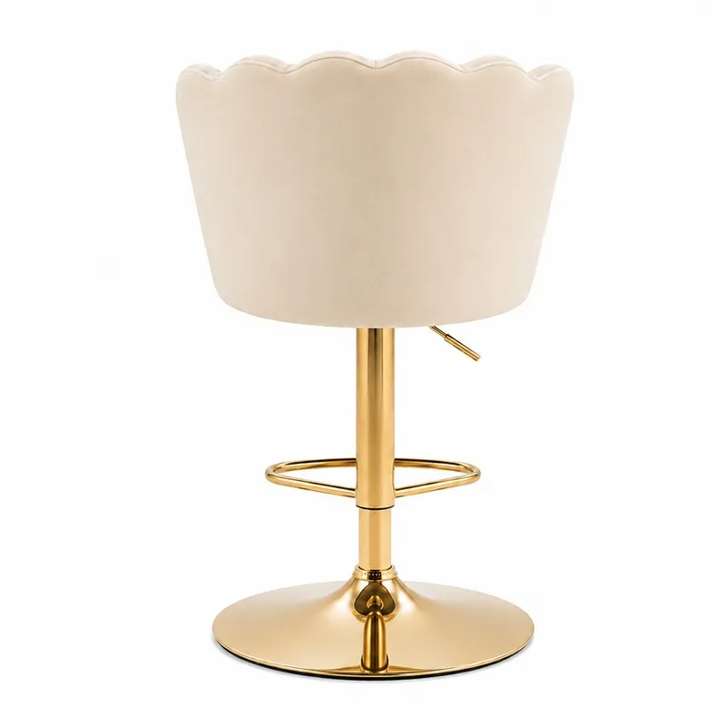 Rear view of a beige velvet bar chair with scalloped back and gold-tone base
