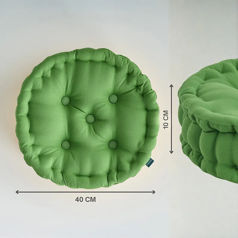 Top and side view of a light green round tufted floor cushion