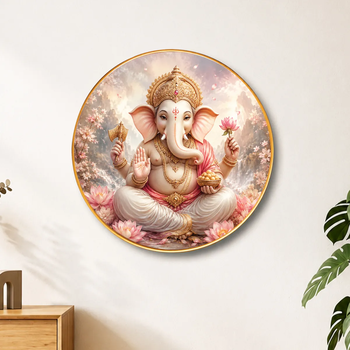 Round Ganesha wall art with pink lotus details on a plain wall