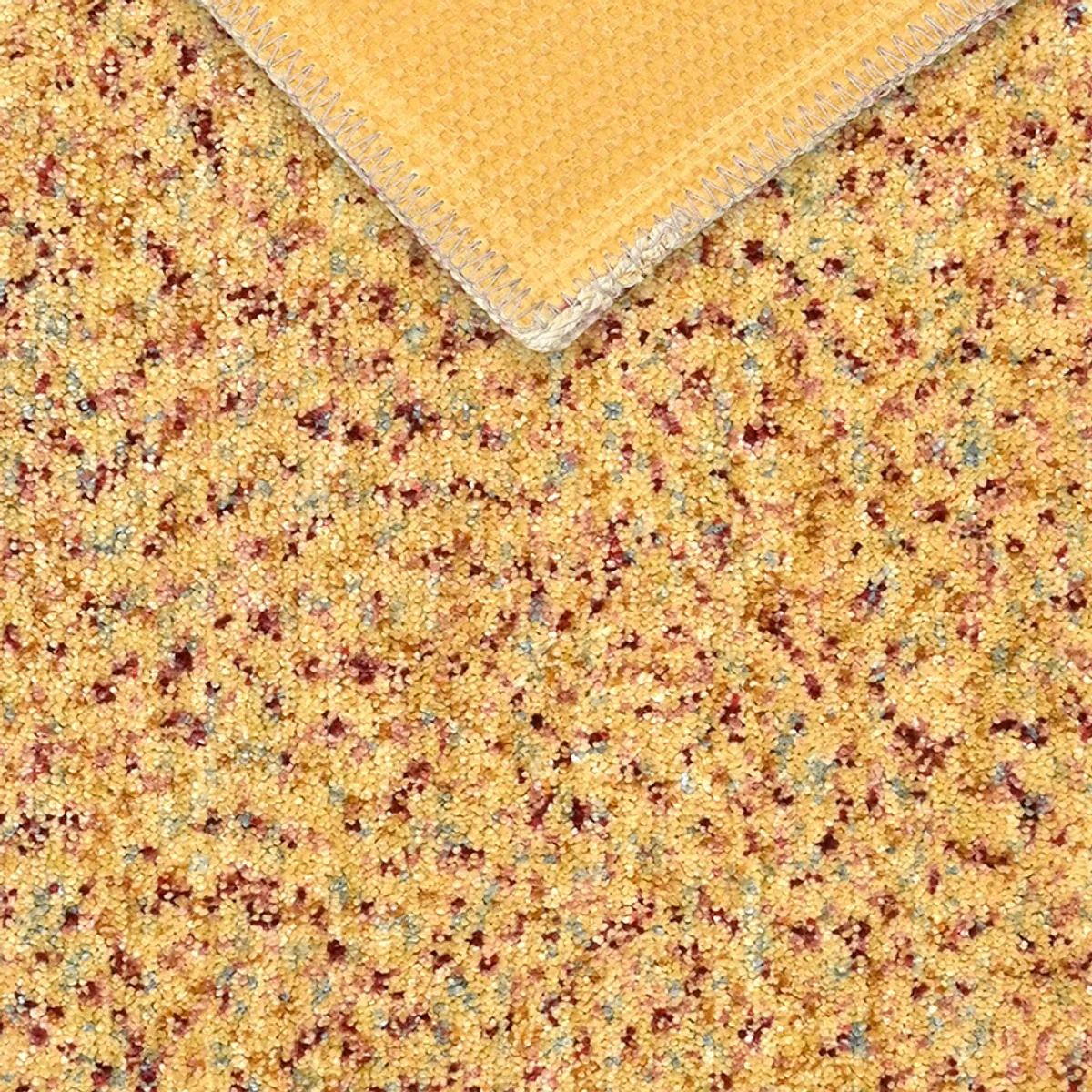 Underside showing the yellow backing and finished edge of the carpet