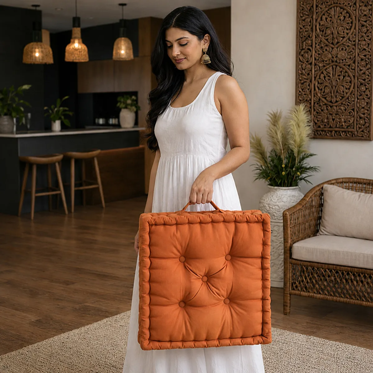 Woman carrying the brown square floor cushion by its side handle