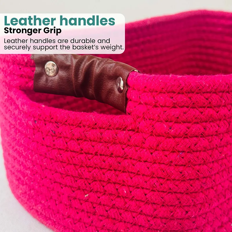 Close-up of the basket's brown side handle against the dark pink textured surface