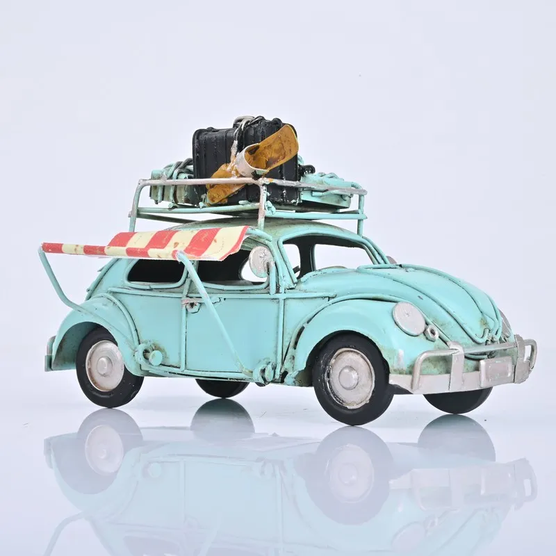Side view of blue vintage beetle car showpiece with striped awning detail