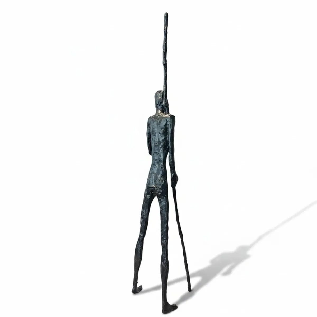 Rear view of the tall black figurative sculpture