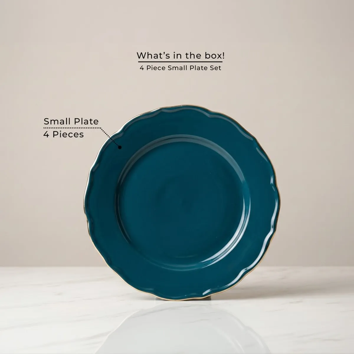 Single dark teal scalloped plate with gold rim on display