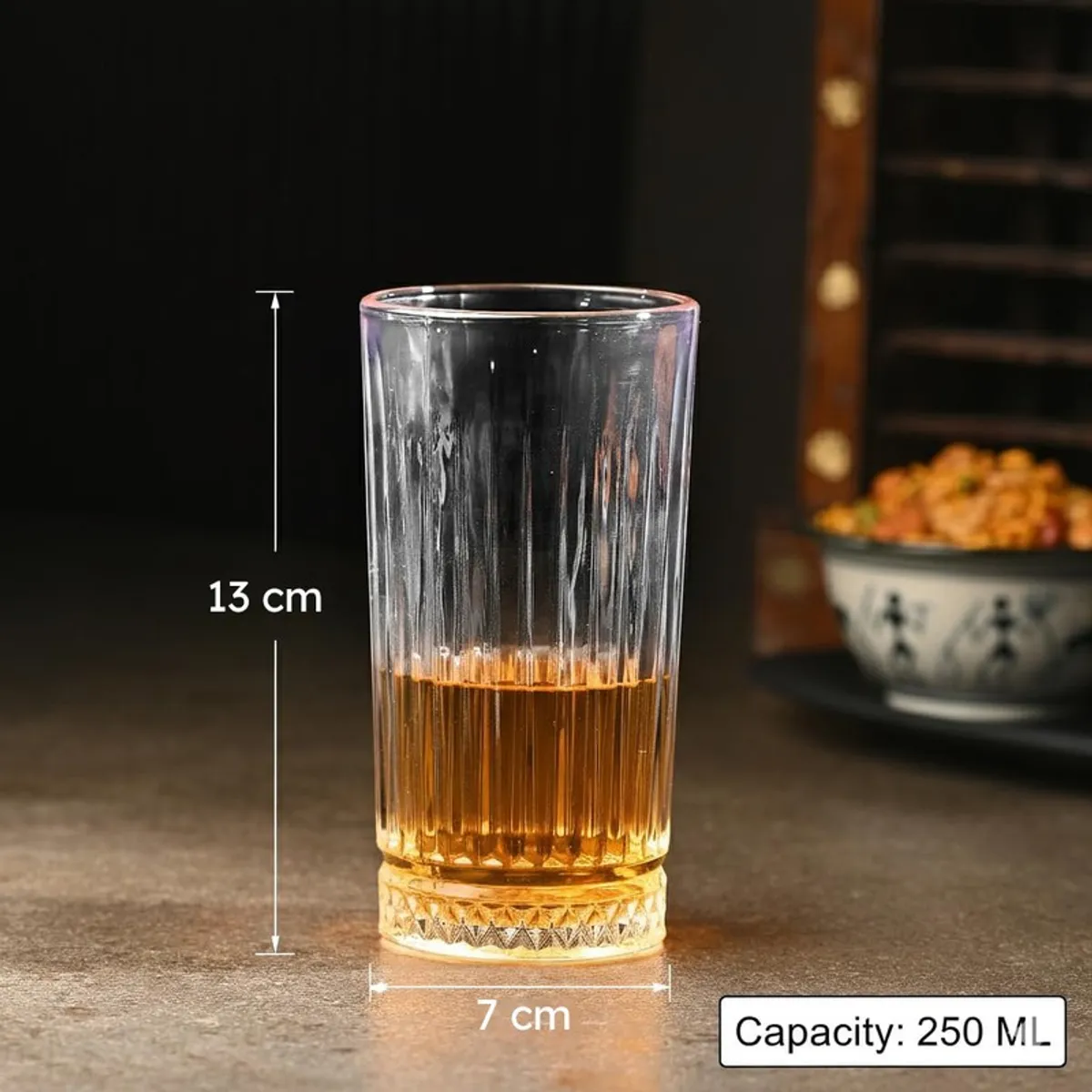 Clear textured drinking glass with amber drink shown with size markings