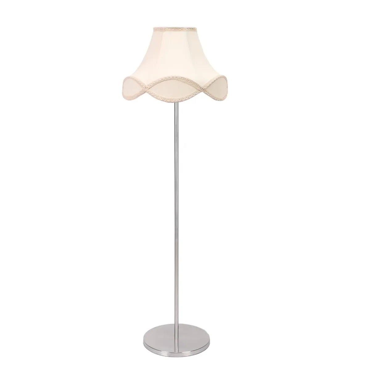 Floor lamp glowing warmly beside a sofa and leafy plant