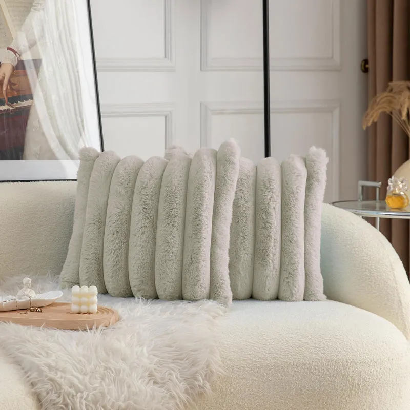 Pale grey plush striped cushion cover displayed on a light sofa.