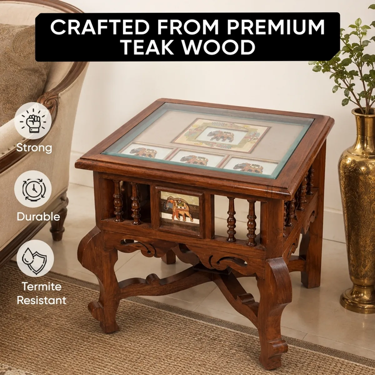Brown teak wood side table with a square top and carved legs in a living room