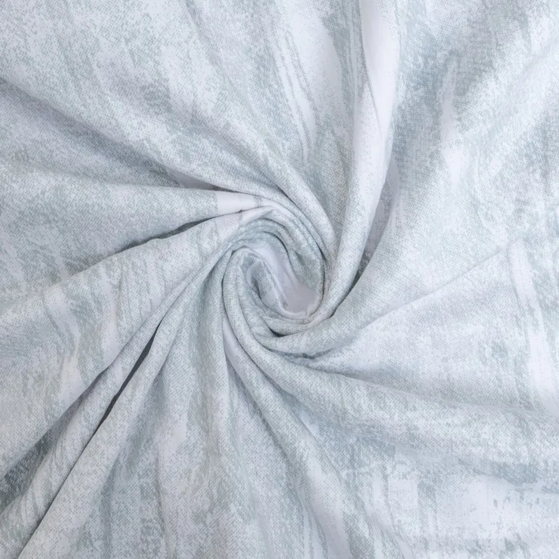 Close-up of the pale green abstract printed cotton fabric.