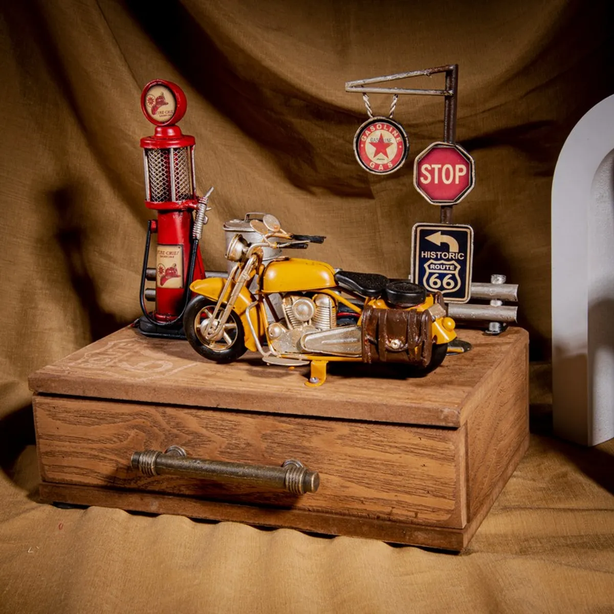 Wooden storage box styled with a yellow motorcycle and red vintage petrol pump