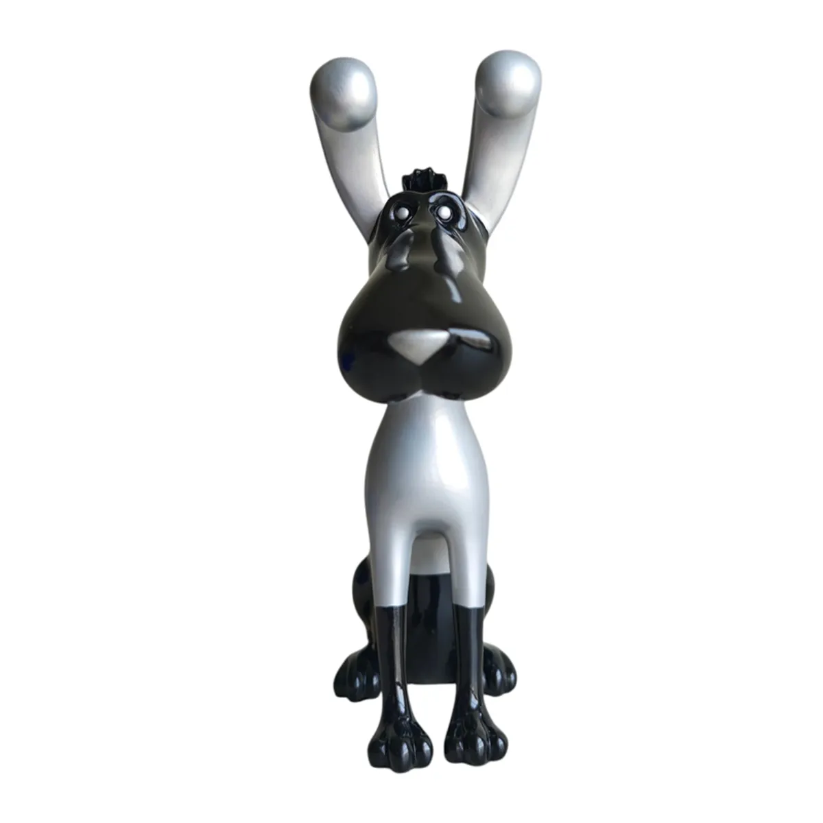 Front view of a glossy black and silver abstract dog sculpture