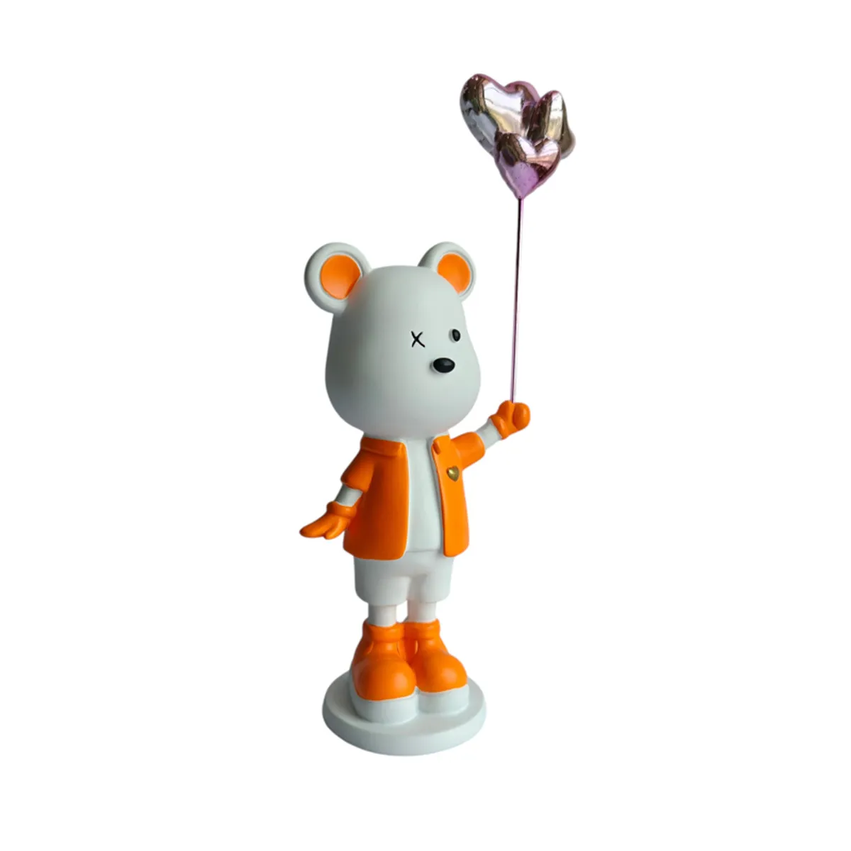 Side view of the orange and white bear holding a balloon