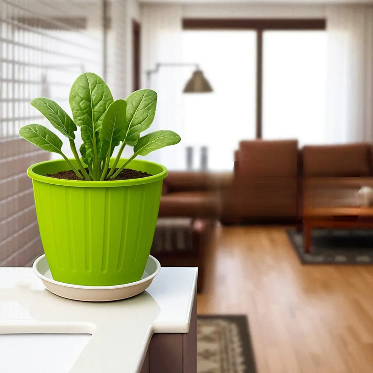 Bright green planter with leafy plant and white drip tray displayed in a modern interior.