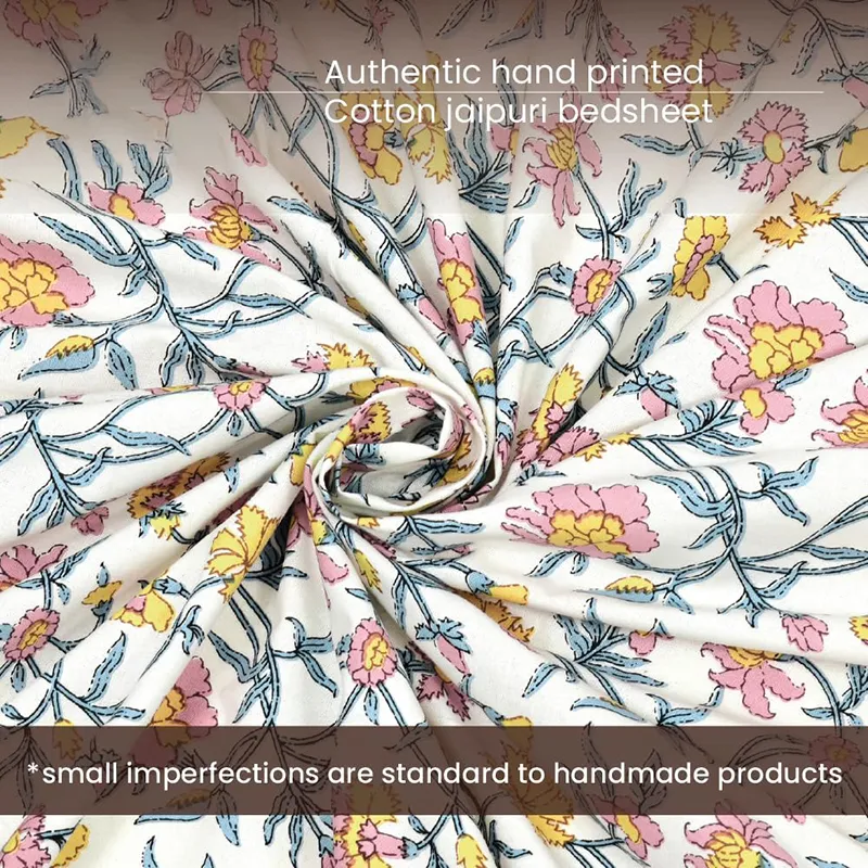Close-up of floral cotton fabric in off-white, blue, pink and yellow tones