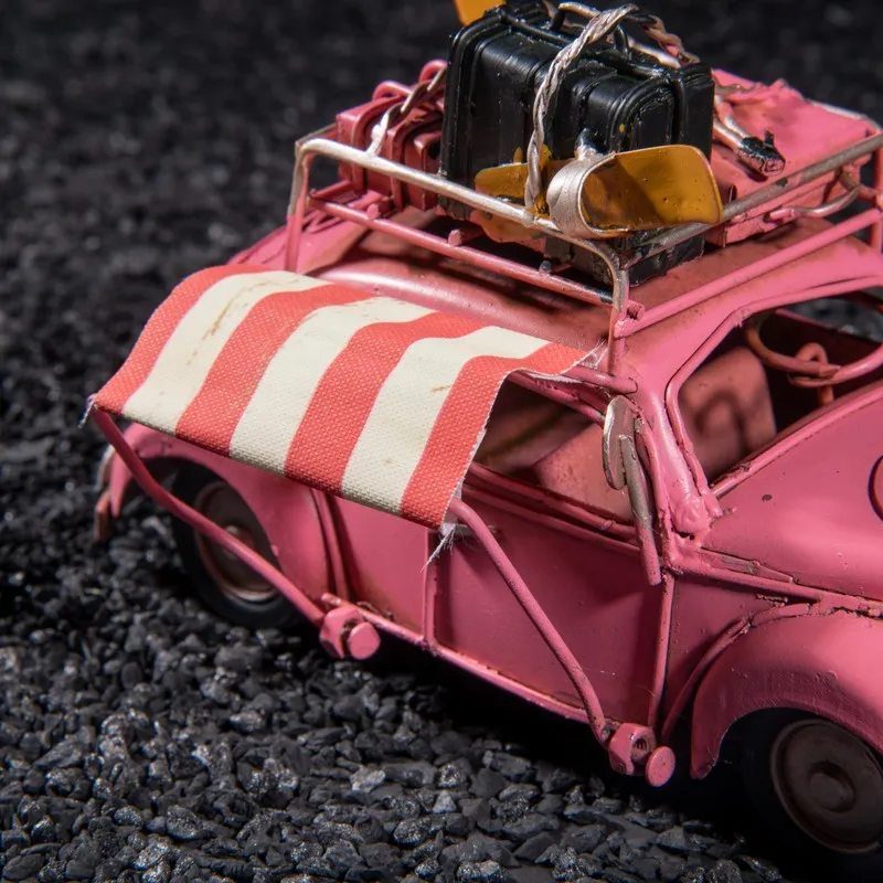Close-up of pink beetle car showpiece with striped awning detail