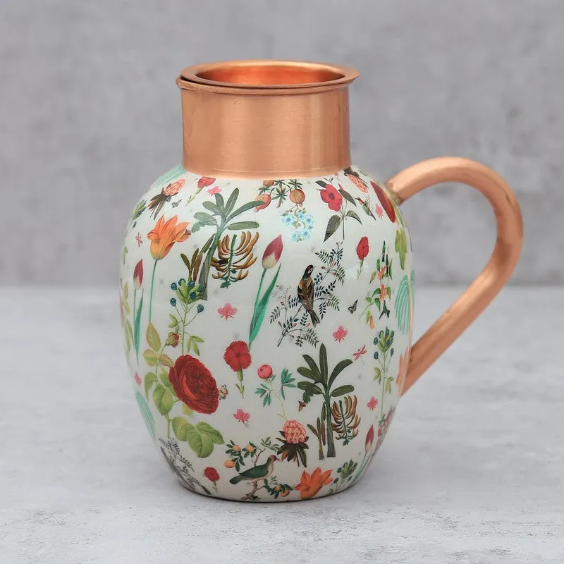 Close-up of the floral and bird artwork on a copper jug