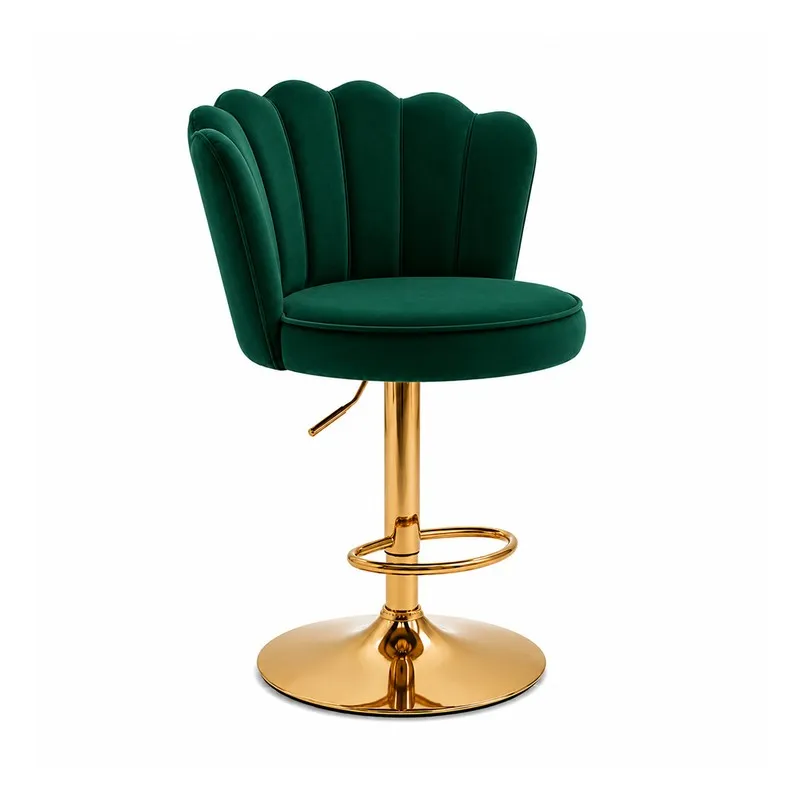 Angled view of green velvet bar chair with scalloped back and gold-toned metal base