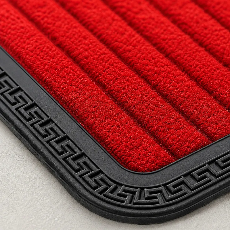 Close-up of the red ribbed surface and black rubber border of the mat