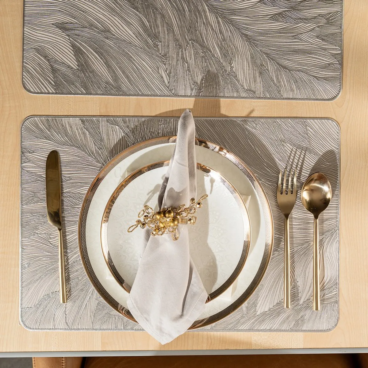 Single grey rectangular table mat styled with plate, napkin and cutlery