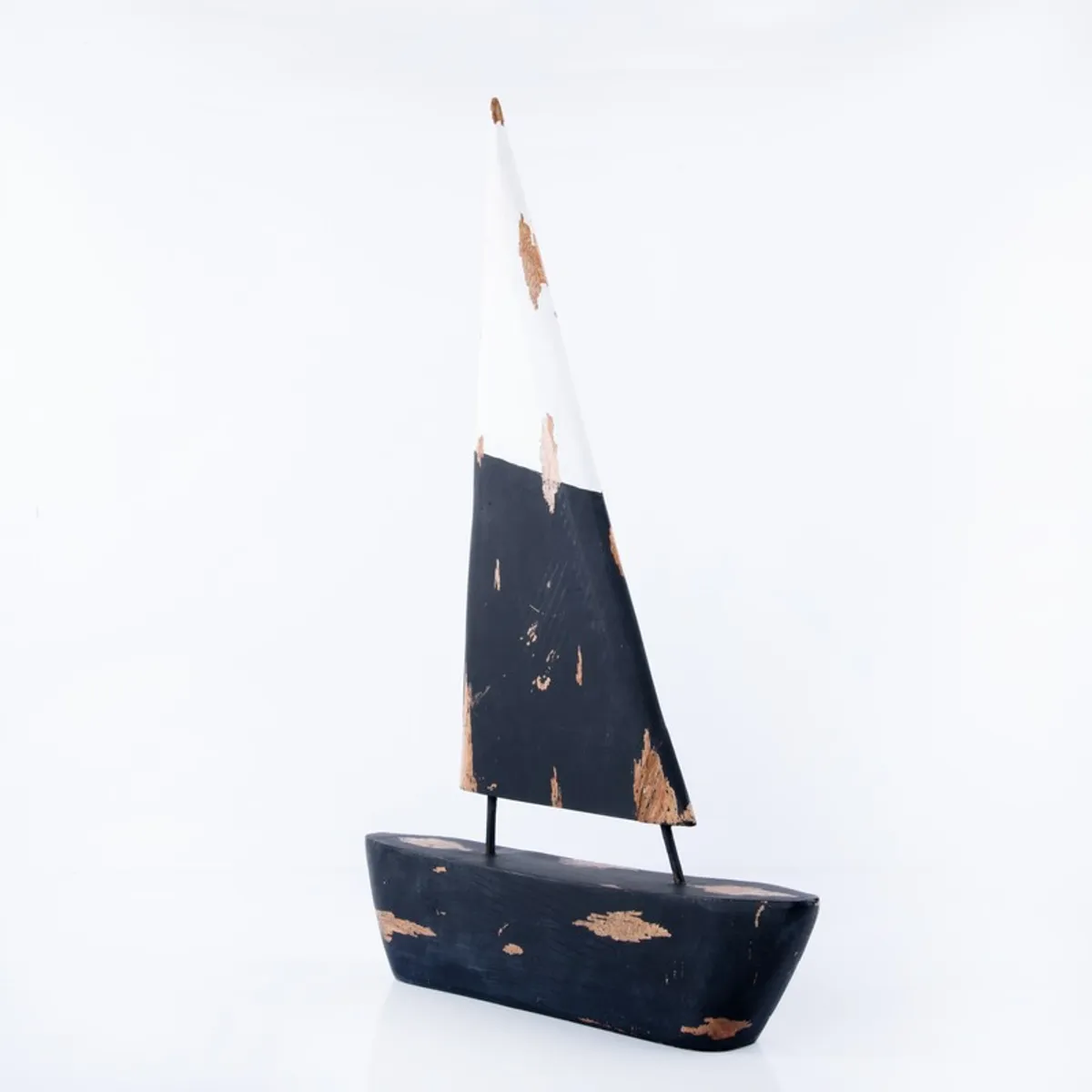 Front view of a black and white wooden sailboat decorative showpiece