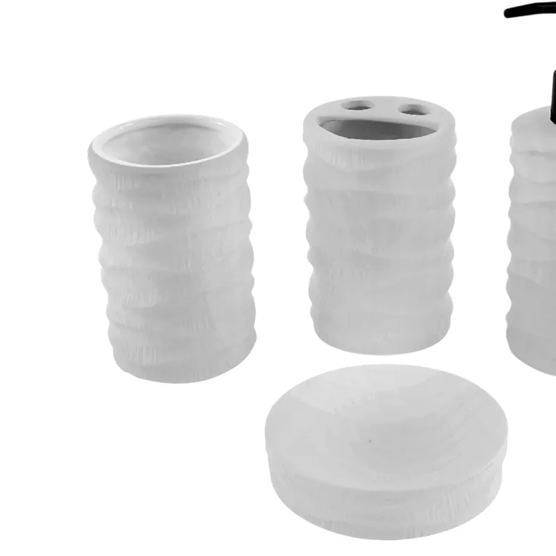 Close view of white ceramic toothbrush holder, soap dish and bathroom accessories