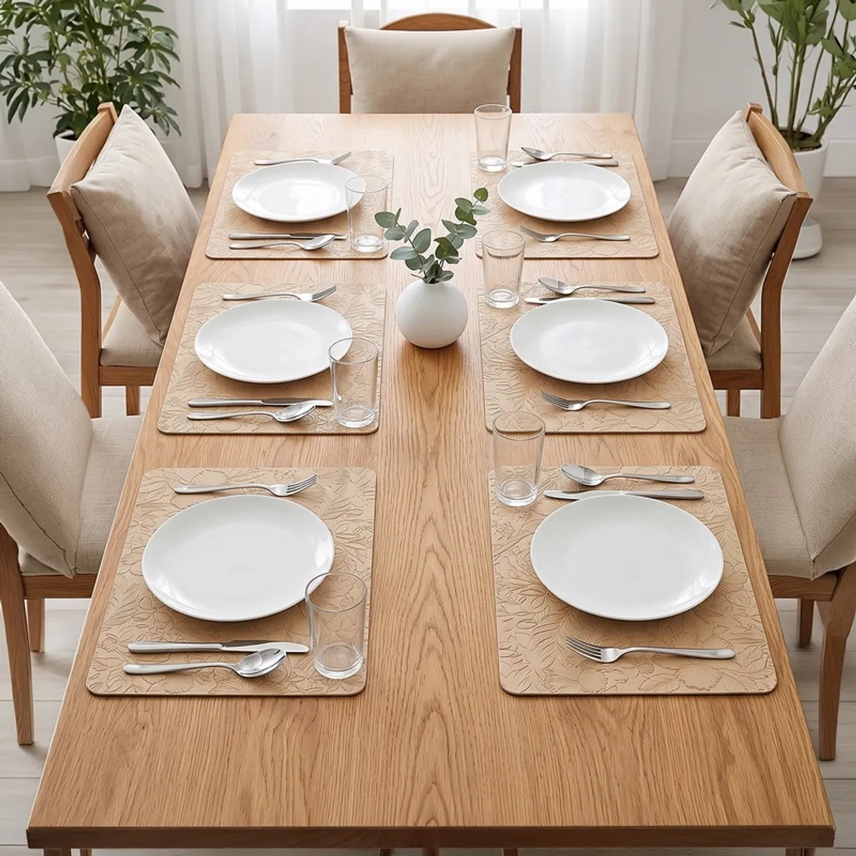Dining table set with six beige rectangular table mats and white plates