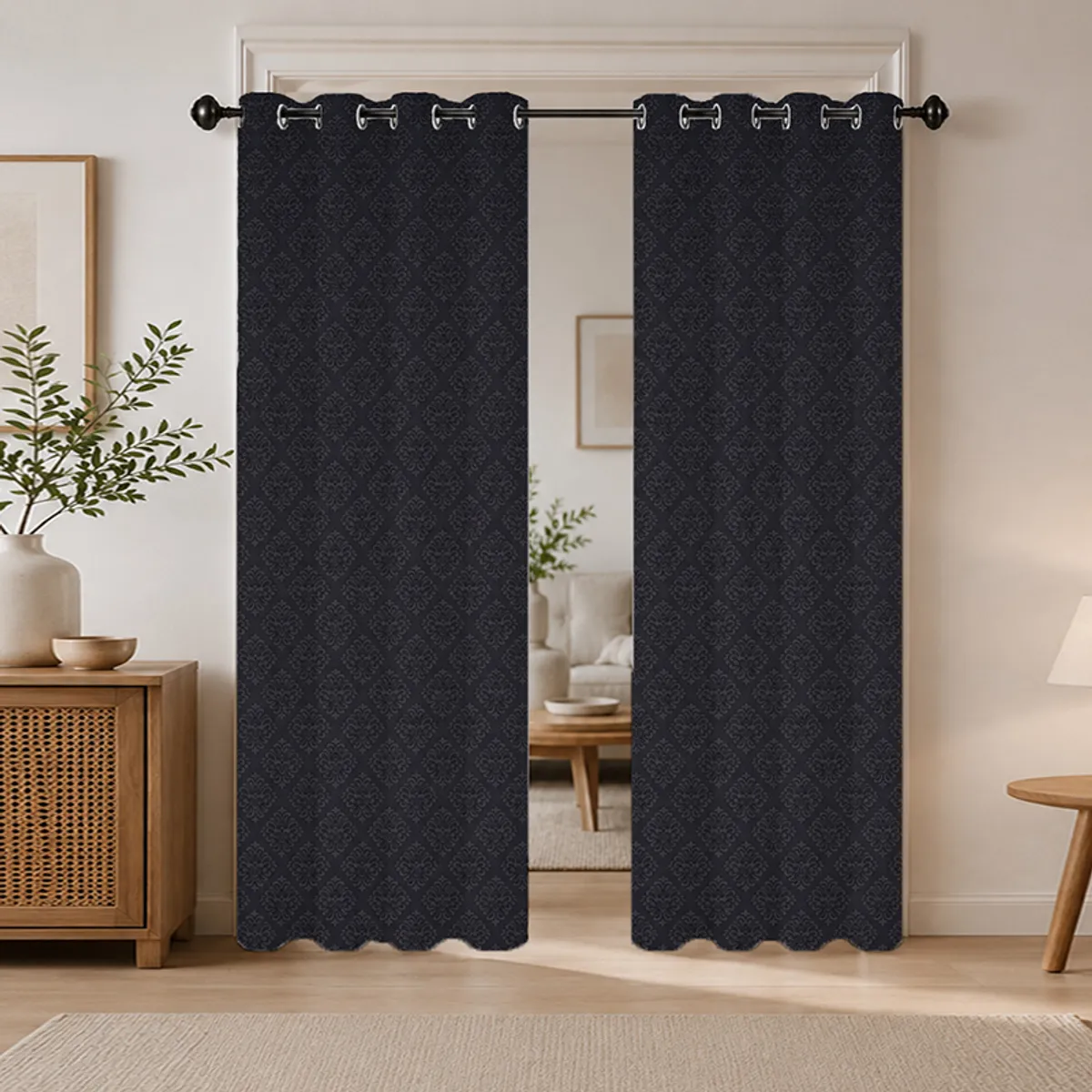 Black patterned eyelet curtains styled in a living room doorway