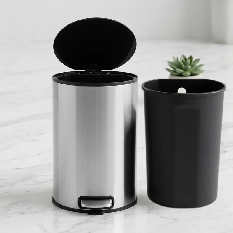 Silver pedal dustbin with open lid beside removable black inner bucket