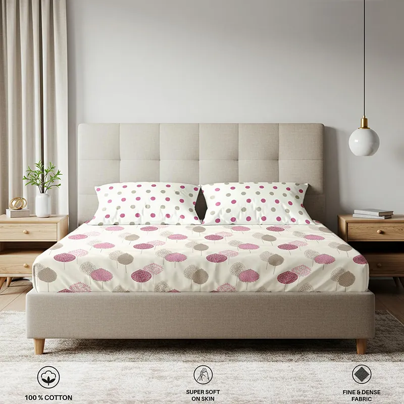 Front view of pink printed fitted bedsheet with matching pillow covers on a bed