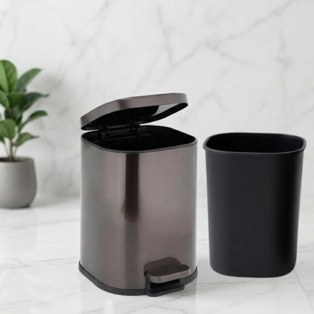 Open metal dustbin with removable inner bucket placed beside it