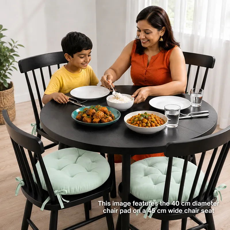 Dining table setup with sage green chair pads on black chairs