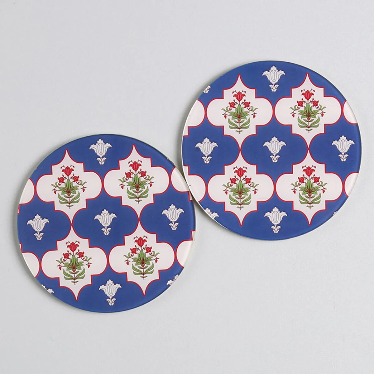 Close-up of two matching blue floral patterned coasters
