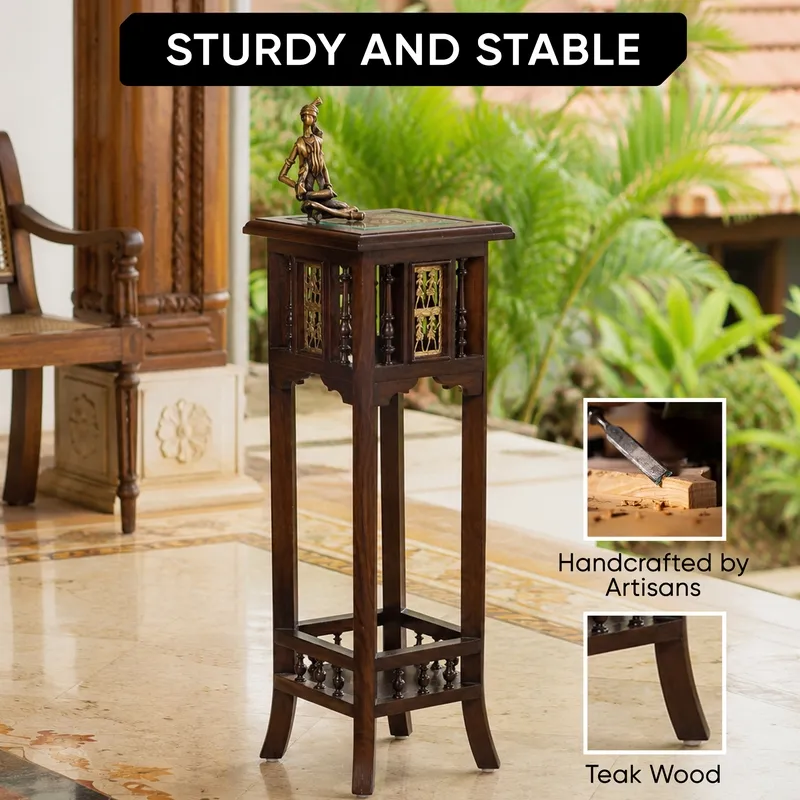 Tall handcrafted wooden side table with carved details and brass-toned accents.