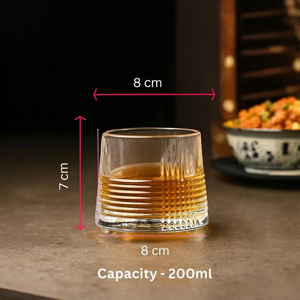 Single clear whiskey glass with textured lower half and measurement markings shown