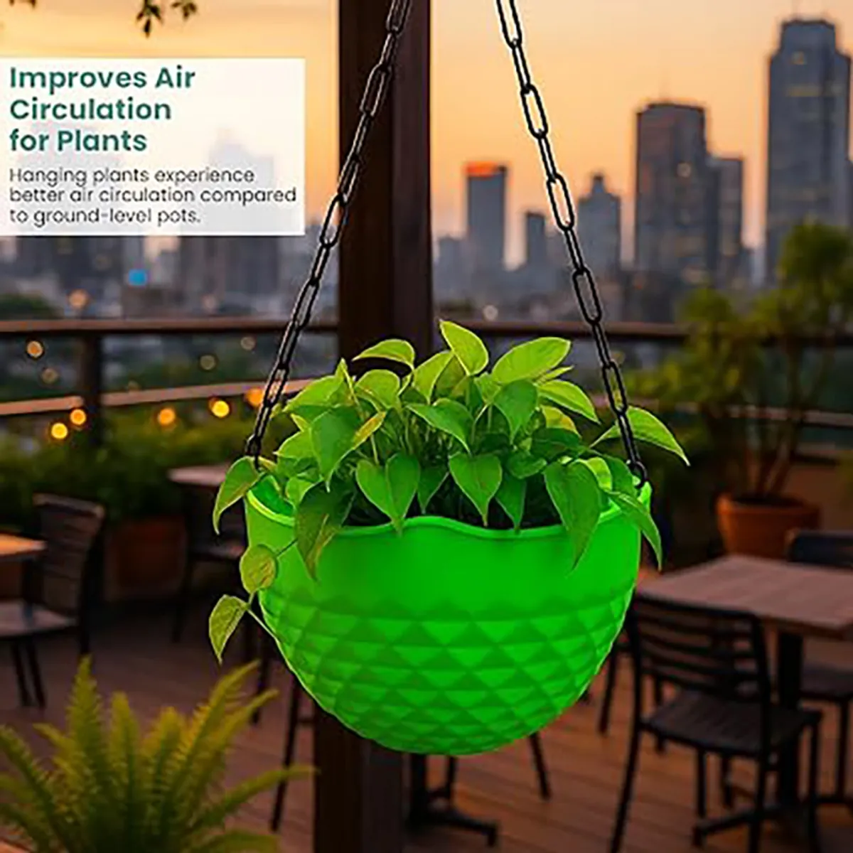 Bright green hanging planter with leafy plant displayed on a city balcony.