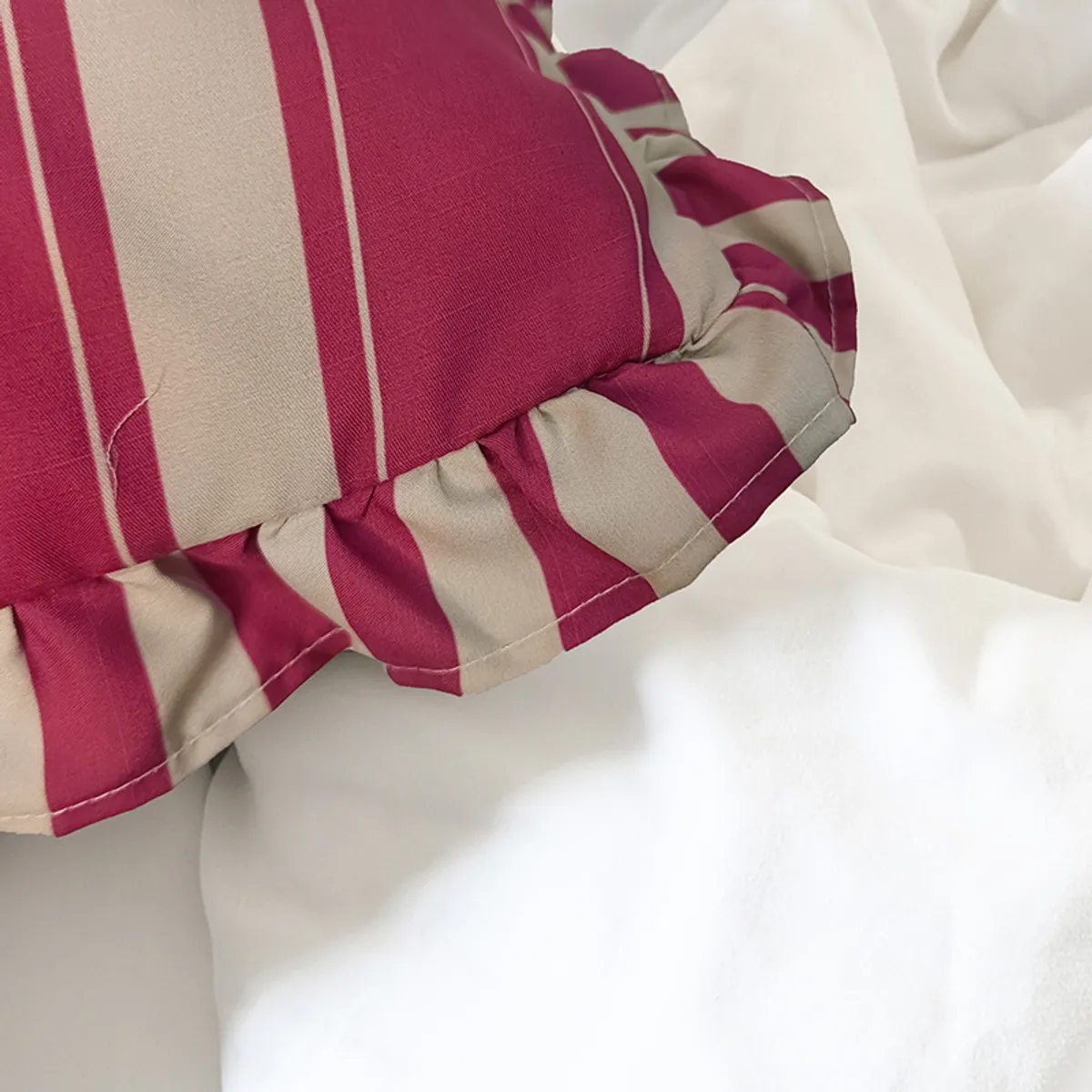 Close-up of the purple striped fabric and ruffled edge on a cushion cover