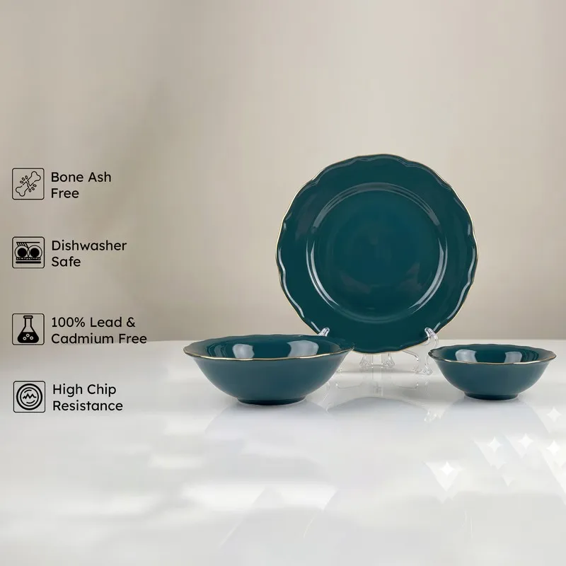 Dark teal plate and bowls with gold rim on display stands