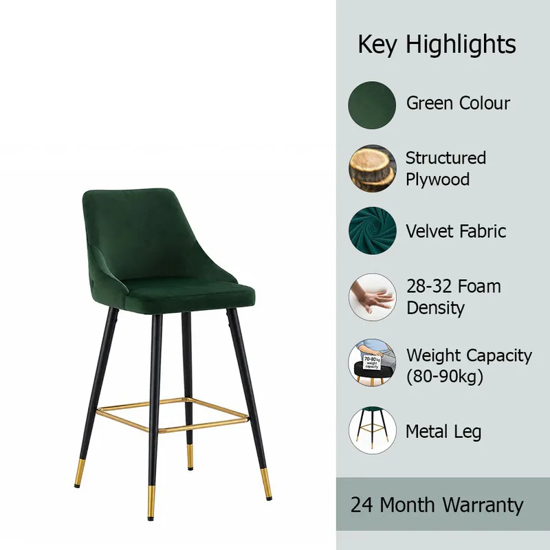 Green bar chair with velvet upholstery and black legs on a white background